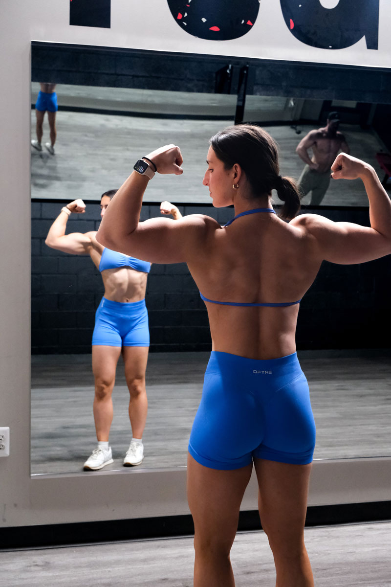 The coach is posing in front of the mirror.